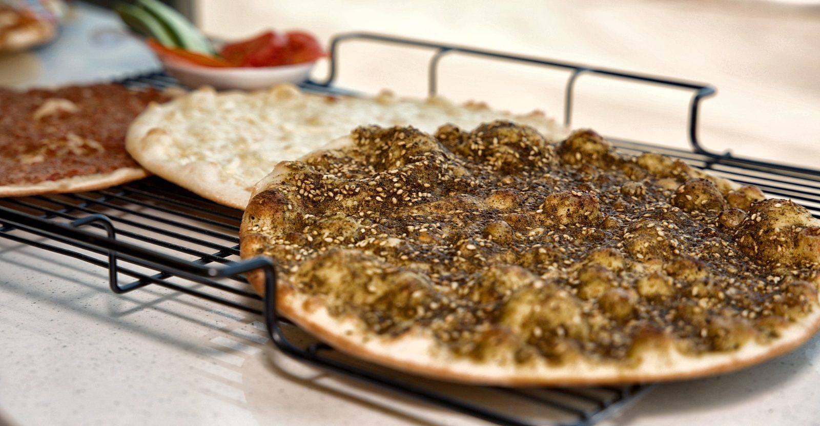 Golden zaatar manoushe topped with sesame, hot from the oven
